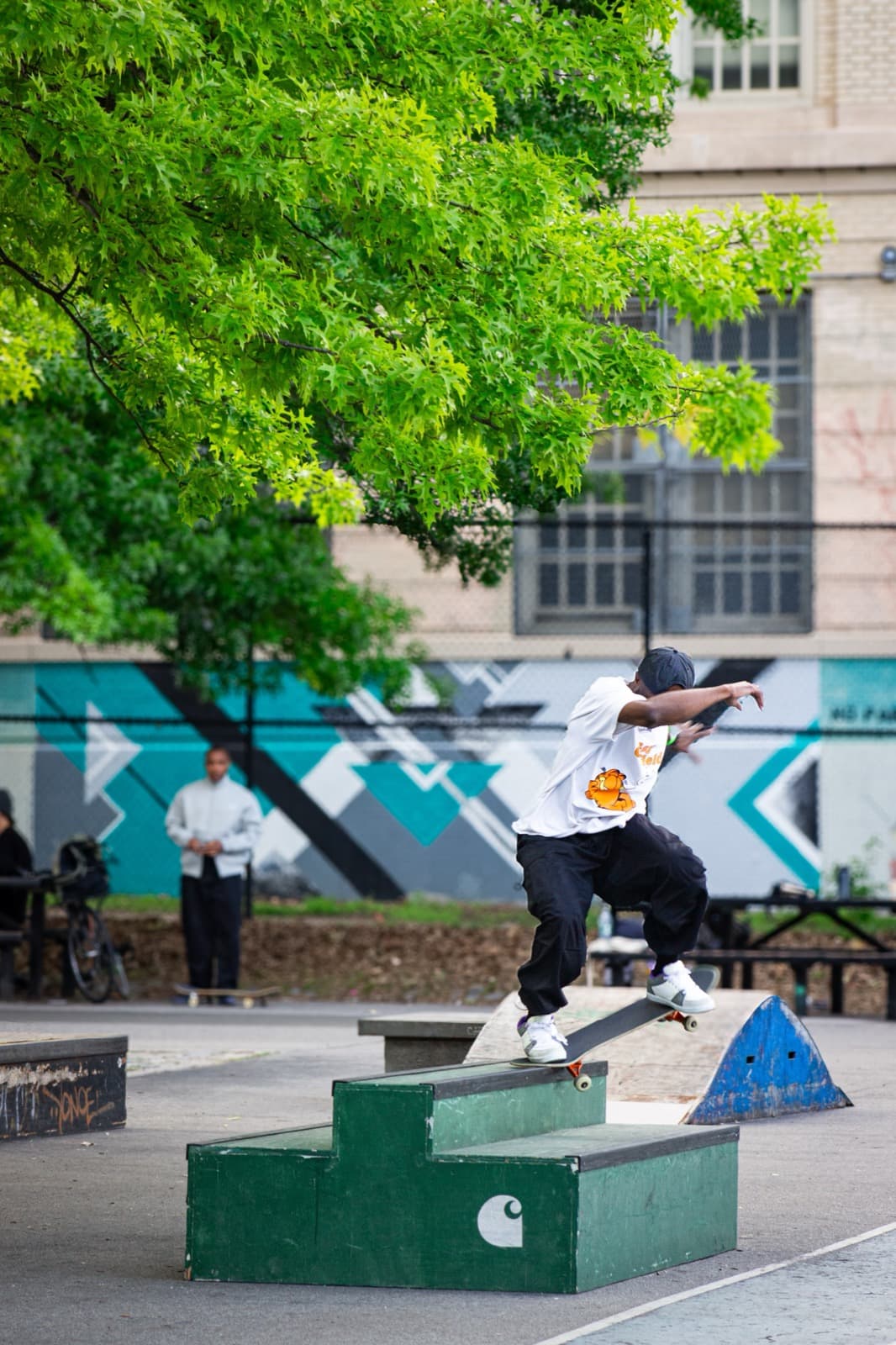 Leon Toppin skateboarding at full speed through a New York City park