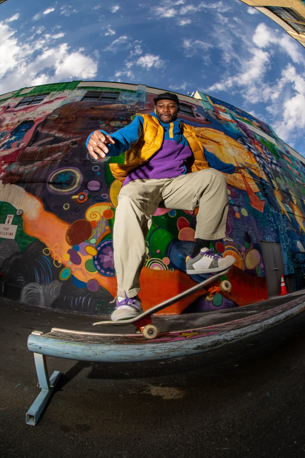 Young skater focused on learning a new trick at a New York City skatepark