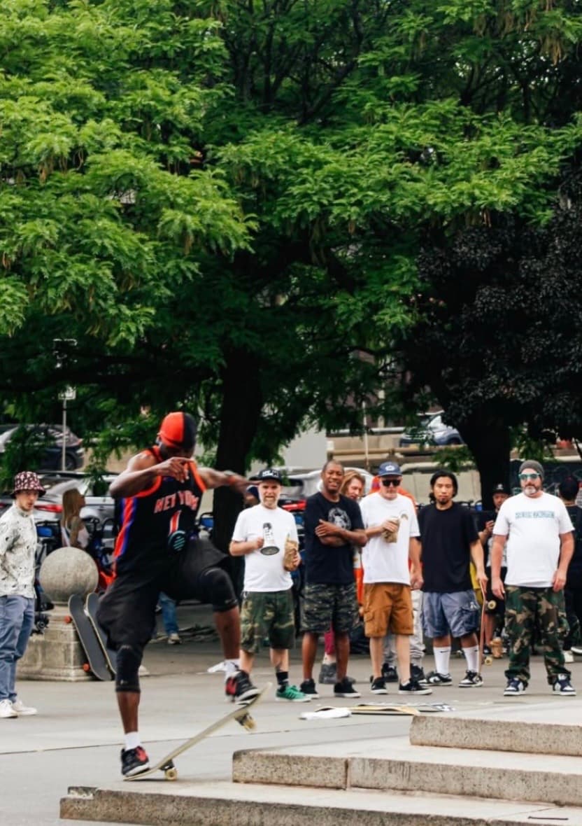 Leon Toppin surrounded by skaters at a community skate event